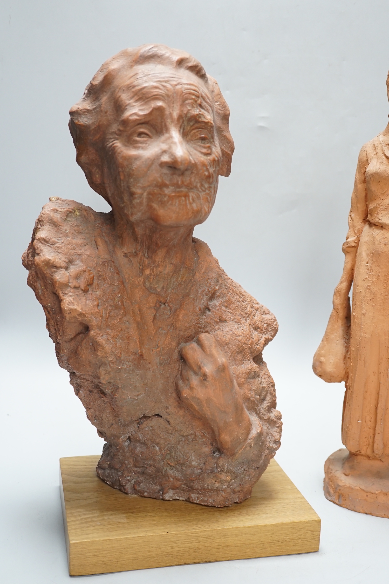 Marcus Cornish (1964-) - ‘’Refugee’’, a terracotta sculpture and one other terracotta sculpture of a mother and child, indistinctly signed, the largest 46cm high (2)